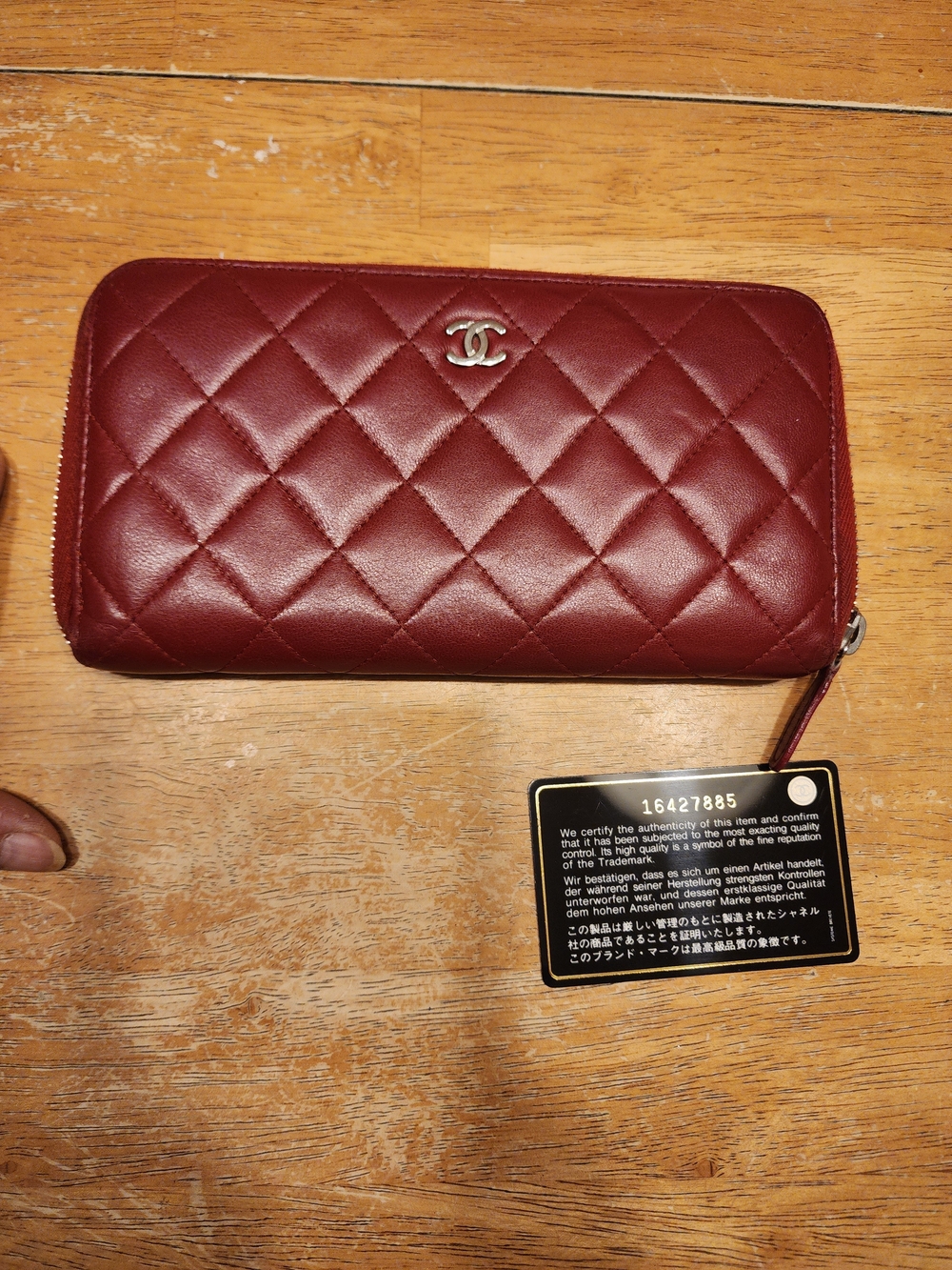 a Chanel Matelasse quilted leather round zipper long wallet in a red color